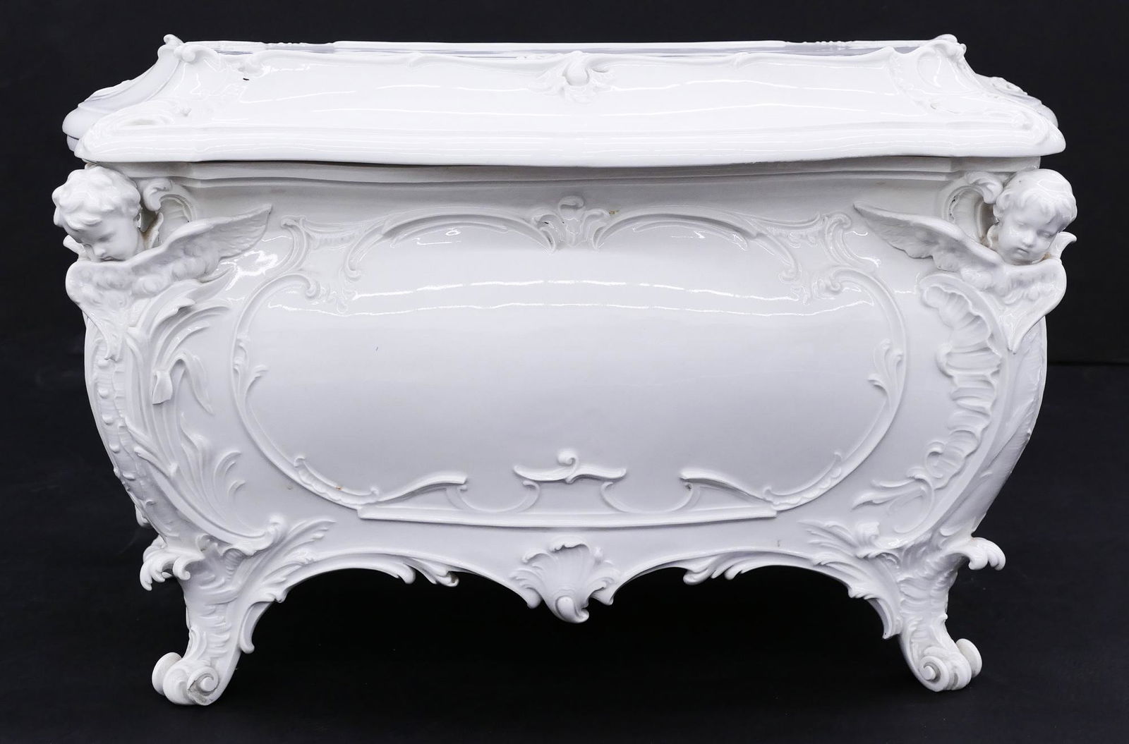KPM Royal Berlin Blanc de Chine Casket: KPM Royal Berlin Blanc de Chine Casket 12''x21''x10''. A large porcelain baroque covered casket with angel heads at corners. Blue underglaze mark with strike through. Missing one wing on corner with s