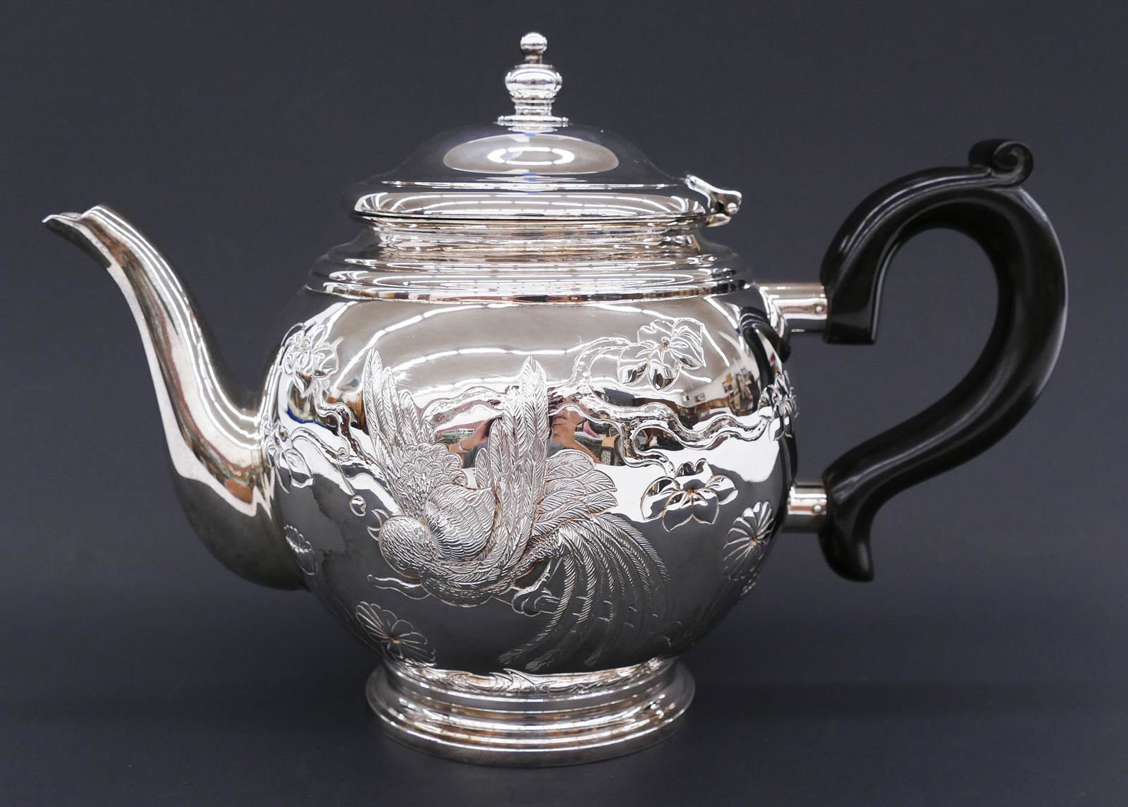 Tiffany & Co. ''Audubon'' Sterling Teapot: Tiffany & Co. ''Audubon'' Sterling Teapot 7''x10''. Impressive hand chased teapot with bird and blossoming flower motif. Marked with form 25933. Like new condition with no monogram. Comes with blue Ti