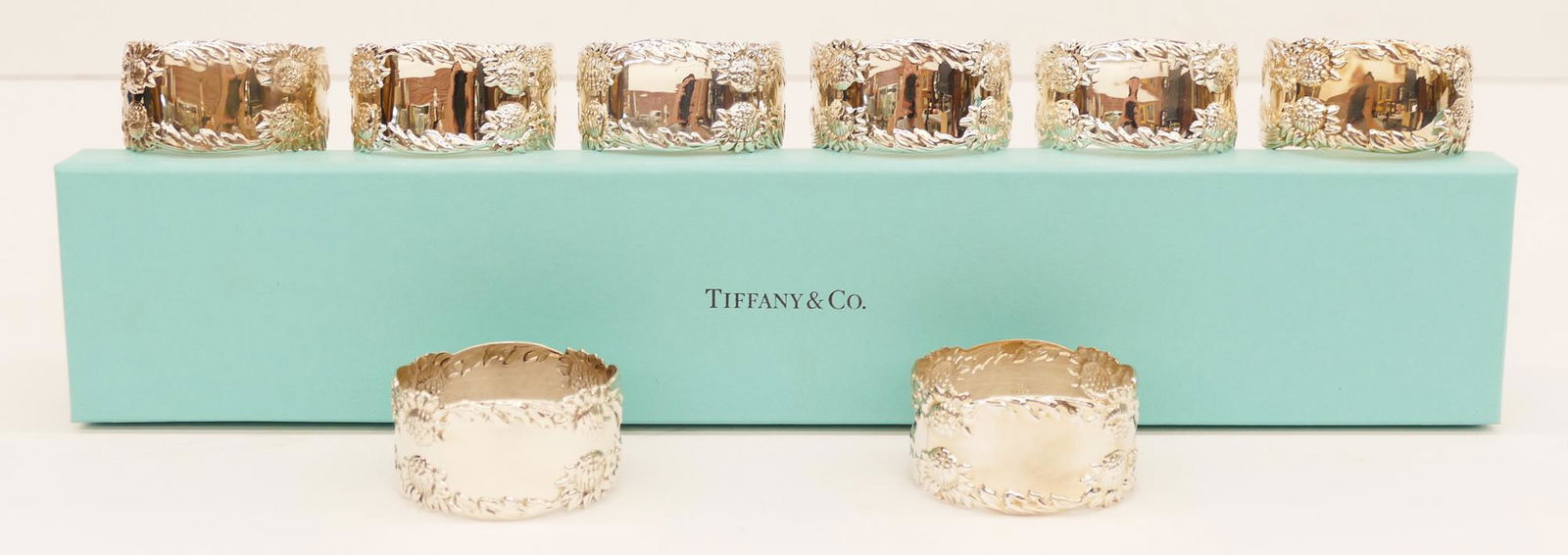 Set 8 Tiffany & Co. ''Chrysanthemum'' Sterling Napkin: Set of 8 Tiffany & Co. ''Chrysanthemum'' Sterling Napkin Rings 2.25''x1.25''. A complete set of floral napkin rings. Marked with form 26076. Like new condition with no monograms. Comes with blue Tiffa