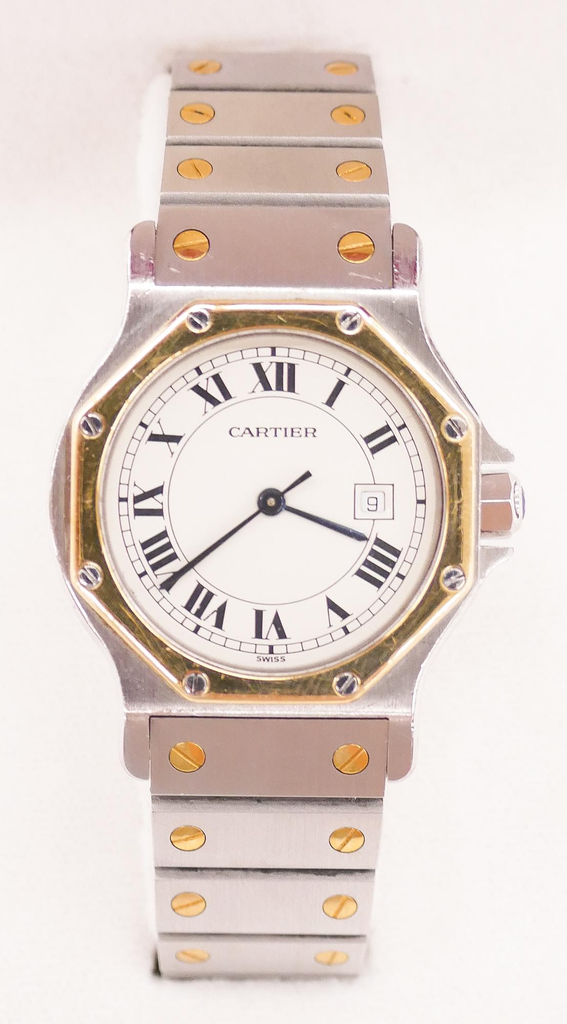 Lady's Cartier Santos 18k Stainless Wristwatch: Lady's Cartier Santos 18k Stainless Wristwatch 29mm. Gold bezel automatic movement date wristwatch. Serial no.296662516. Comes with original red Cartier box. Some surface wear from use.