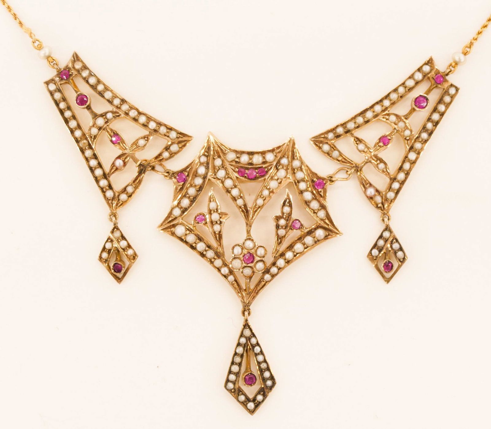 Lady's Edwardian Pink Sapphire & Pearl Necklace: Lady's Edwardian Pink Sapphire & Seed Pearl 12k Festoon Necklace 12''. It consists of (16) mixed cut pink sapphires of 2-2.5mm and approx. (155) seed pearls of 2-3mm. Unmarked. It weighs 14.9 grams.