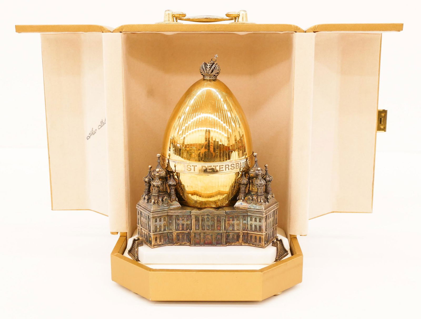 Theo Faberge ''St. Petersburg'' Sterling Egg in Case: Theo Faberge ''St. Petersburg'' Sterling Egg in Case 9''x6.5''. A limited edition gilt sterling silver covered egg with interior imperial brocade replica. Numbered 212 of 750 with COA included. Egg ha