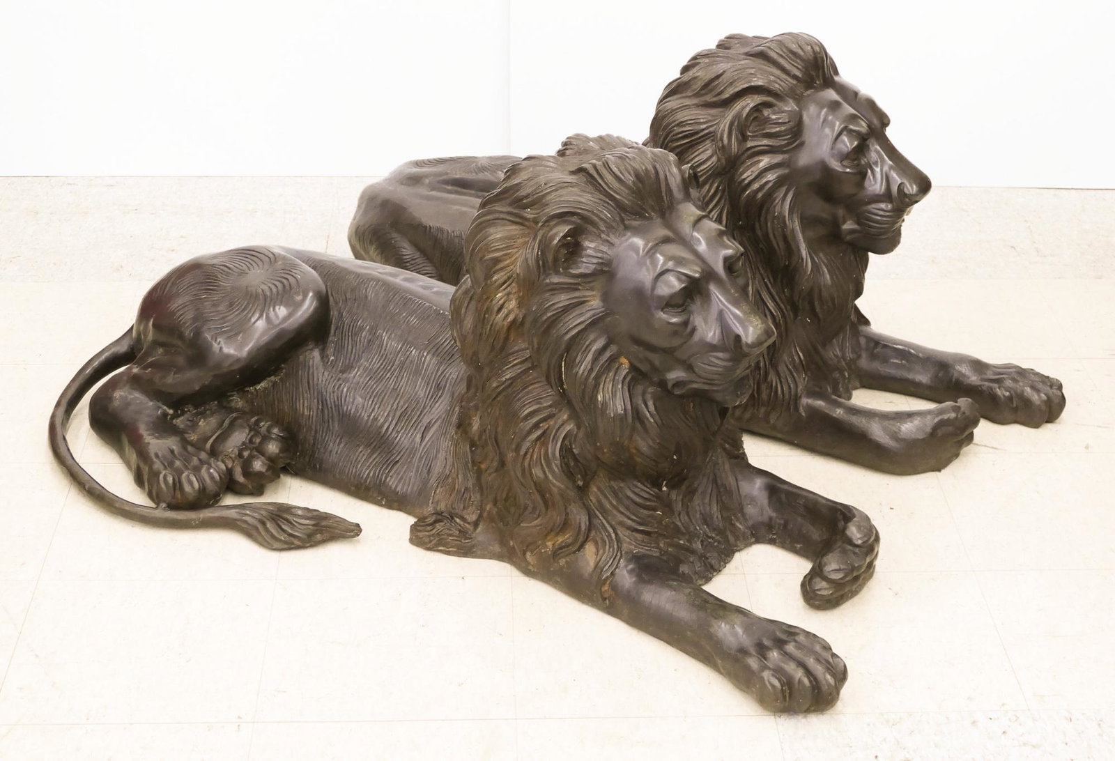 A. Tiot Pair of Life-Size Reclining Bronze Lion: A. Tiot (20/21st Cent. European) Pair of Life-Size Reclining Bronze Lion Sculptures 22''x48''x24''. An opposing pair of reclining garden or guardian lions. Signed on side. 20th century.