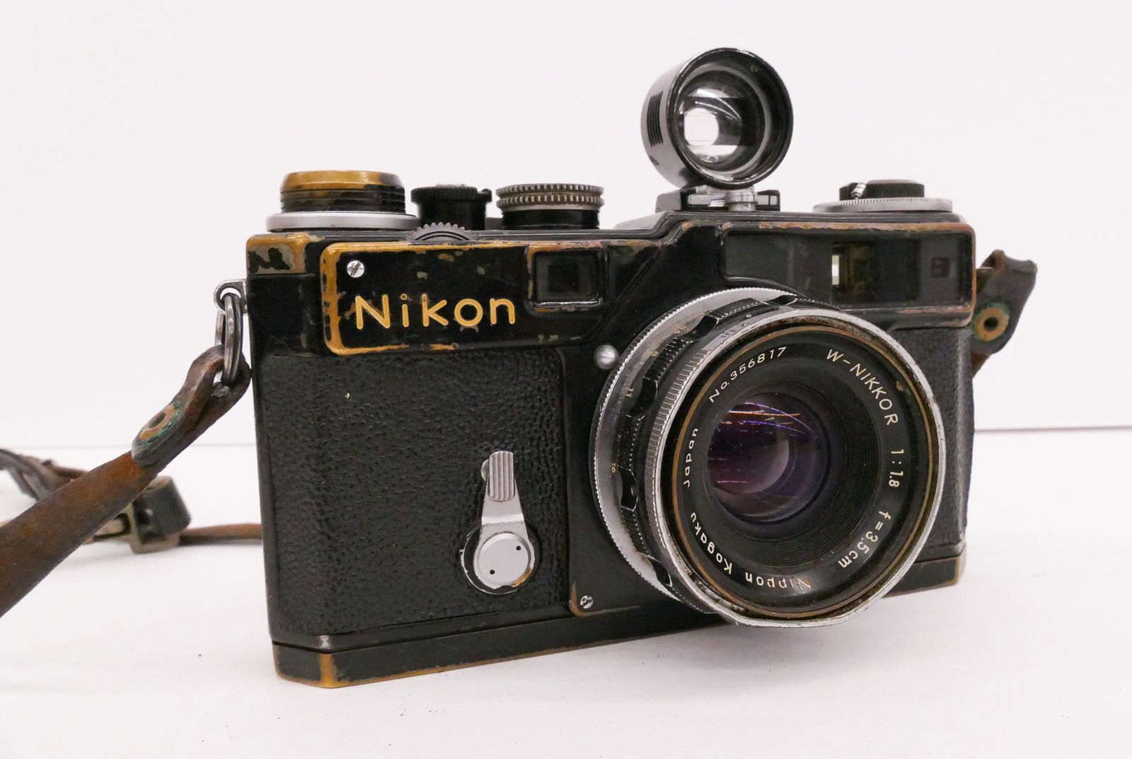 Nikon Black SP 35mm Rangefinder Camera: Nikon Black SP 35mm Rangefinder Camera. Serial #6215387. Comes with W-Nikkor 35mm f1.8 Lens. Camera is in working condition. Heavy exterior wear from use with scuffs and some wear through chrome plati