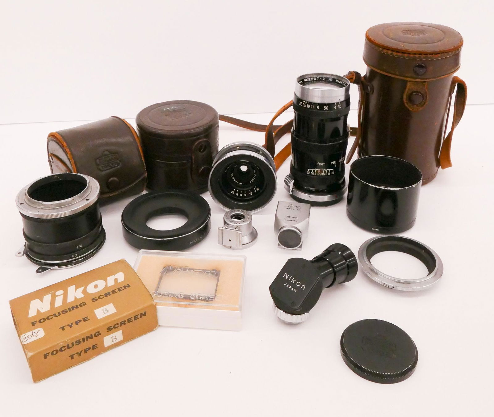 Group Nikon Lenses & Accessories: Group Nikon Lenses & Accessories. Includes Nikkor QC 135mm f3.5 Lens, W-Nikkor 28mm f3.5 Lens, Leitz Wetzlar Cold Shoe Viewers for 135mm and 28mm lenses, Lens Extension Tubes labeled K2, K3,K4, and K5