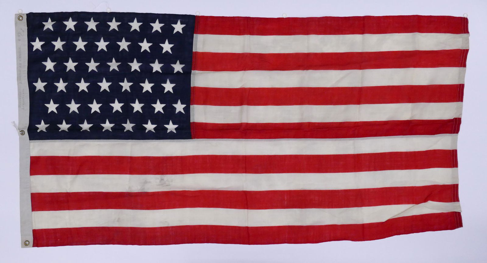 Antique American Ensign 6-Ft 42 Star Flag: Antique American Ensign 6-Ft 42 Star Flag. 'Patented Apr. 26th 1870' stamped along Hoist. Flag measures 37.75'' x 6'. Overall good condition with strong colors, some small scattered snags and areas of