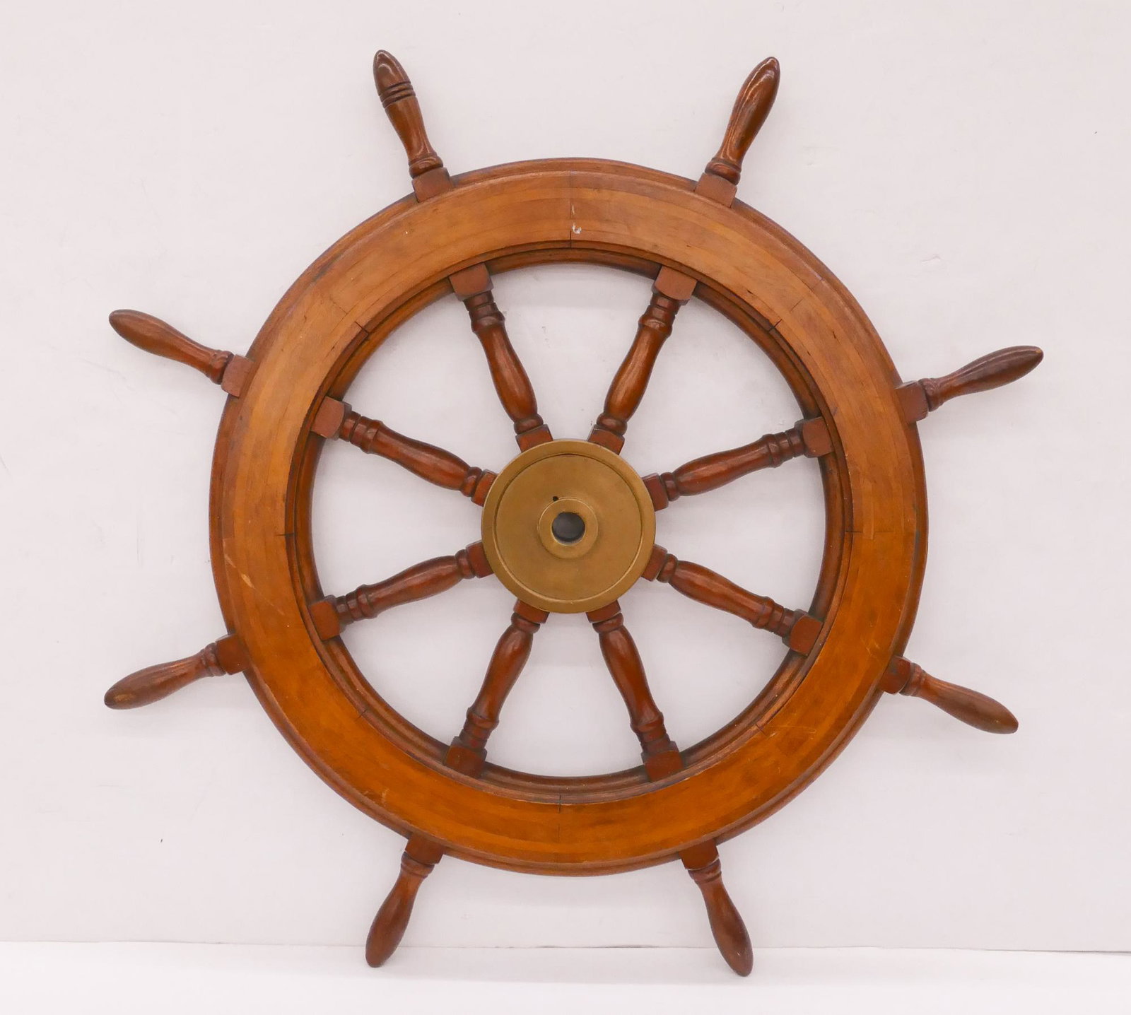 Old Wood and Brass Ship's Wheel: Old Wood and Brass Ship's Wheel. Measures 43" in diameter with 7.5" diameter brass hub with 1.5" diameter axel shaft hole.