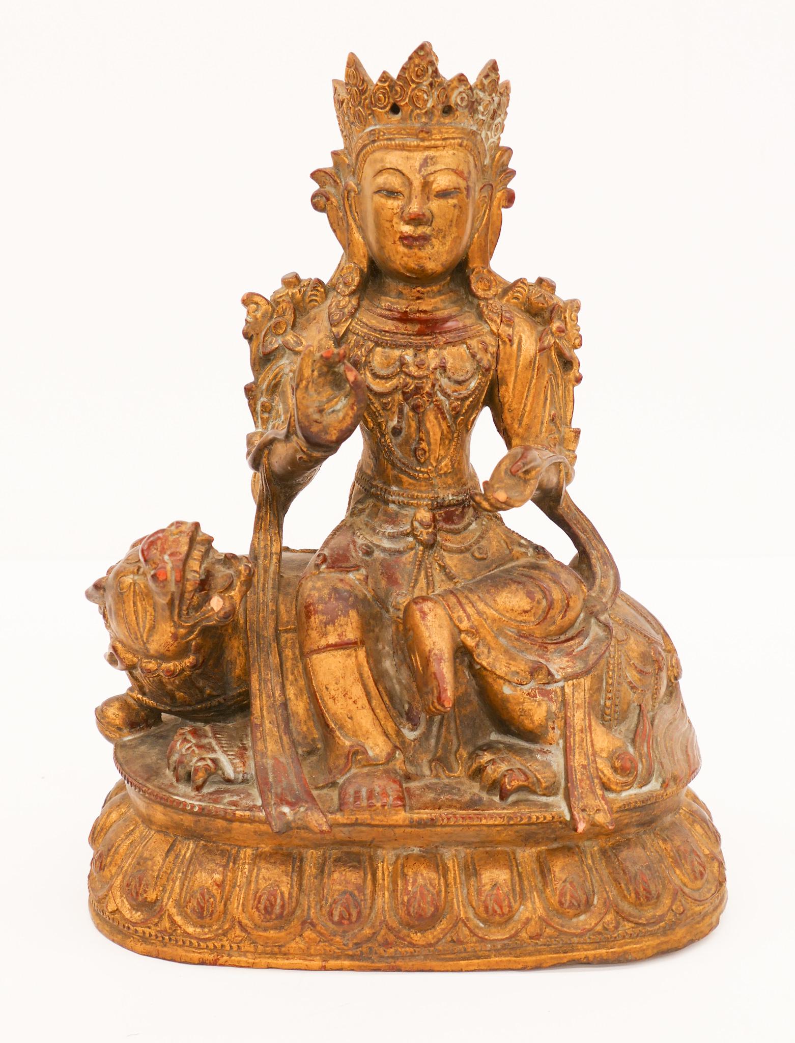 Old Tibetan Gilt Maitreya Riding a Qilin: Old Tibetan Gilt Wood Maitreya Buddha Riding a Qilin 11.5''x8.5''x5.5''. Intricately carved gilt and lacquered wood maitreya buddha riding a reclining qilin on lotus throne. A few small chips to finge