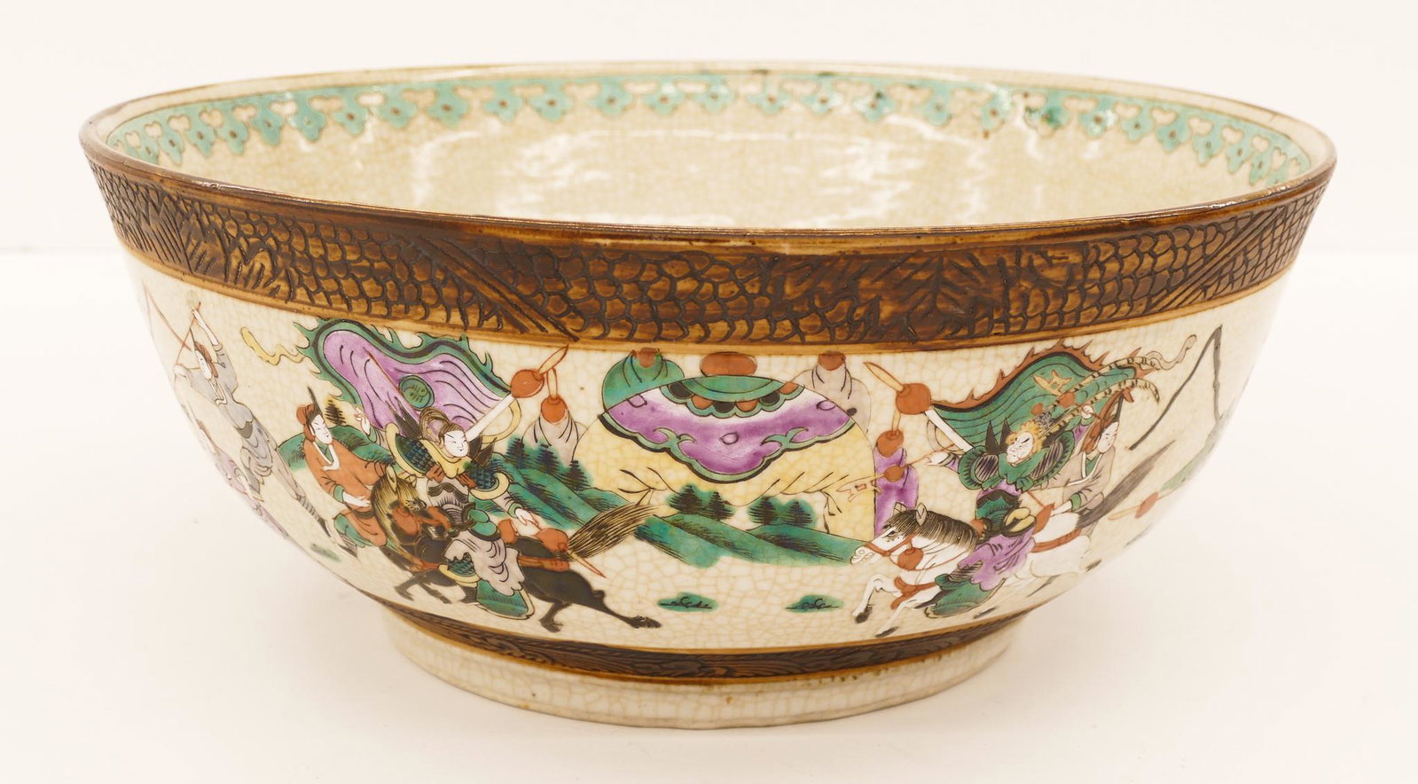 Chinese Qing Nanking Crackle Punch Bowl: Chinese Qing Nanking Crackle Punch Bowl 6.5''x15.5''. Polychrome enameled with warriors in battle motif against a crackle glaze. Turquoise blue interior decorated rim. Carved Chenghua commemorative se