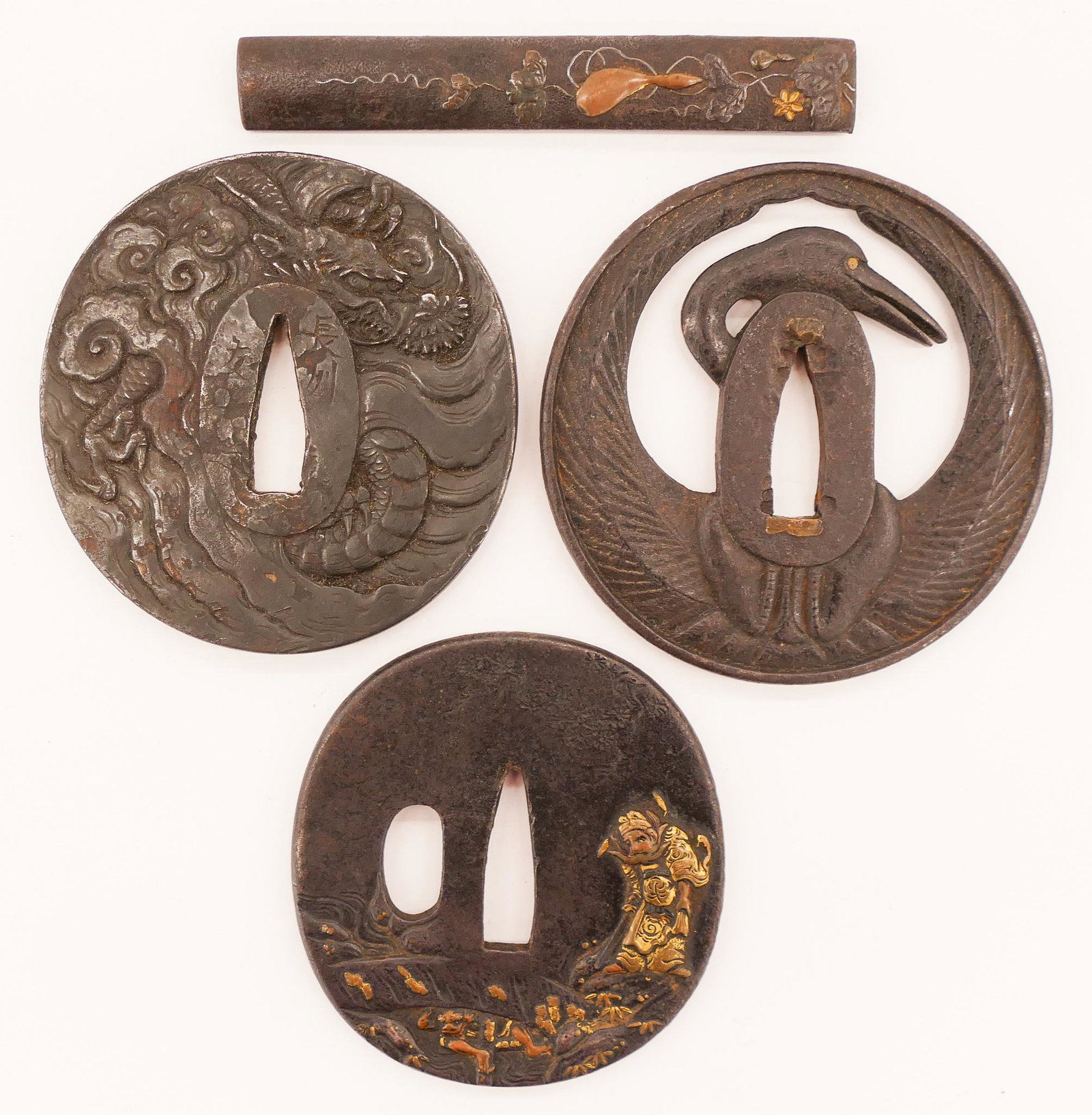 4pc Japanese Meiji Iron Tsuba and Kozuka: 4pc Japanese Meiji Iron Tsuba and Kozuka 3'' to 3.75'' Long. Includes a shakudo kozuka handle with gourd, an iron tsuba with fierce dragon (signed), a pierced crane tsuba, and a shakudo deity with dem