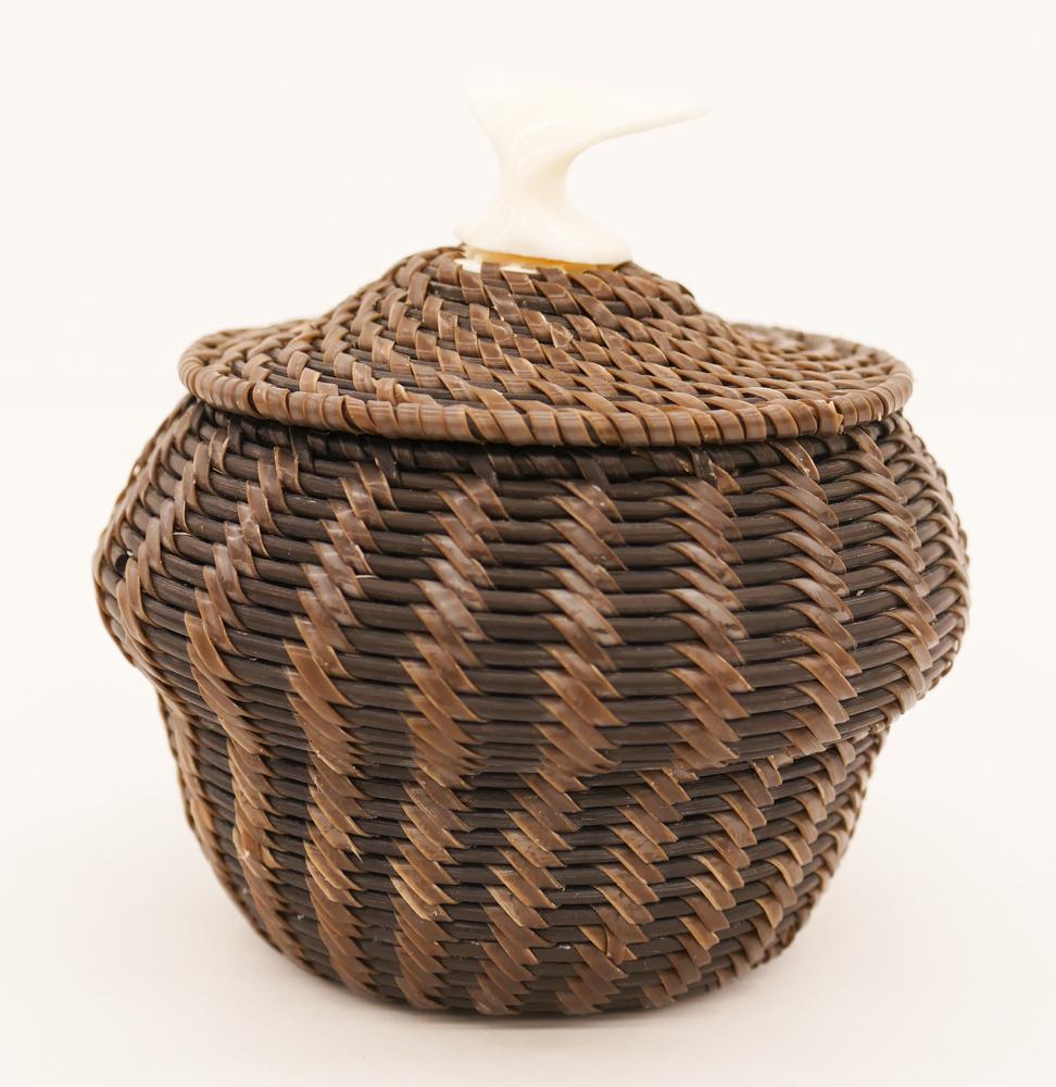 James Omnik Jr. Whale Tail Baleen Basket: James Omnik Jr. (20th Cent. Inuit) Whale Tail Baleen Basket 4''x4''. A finely woven native covered basket with whale tail finial. Signed on bottom. Excellent condition.