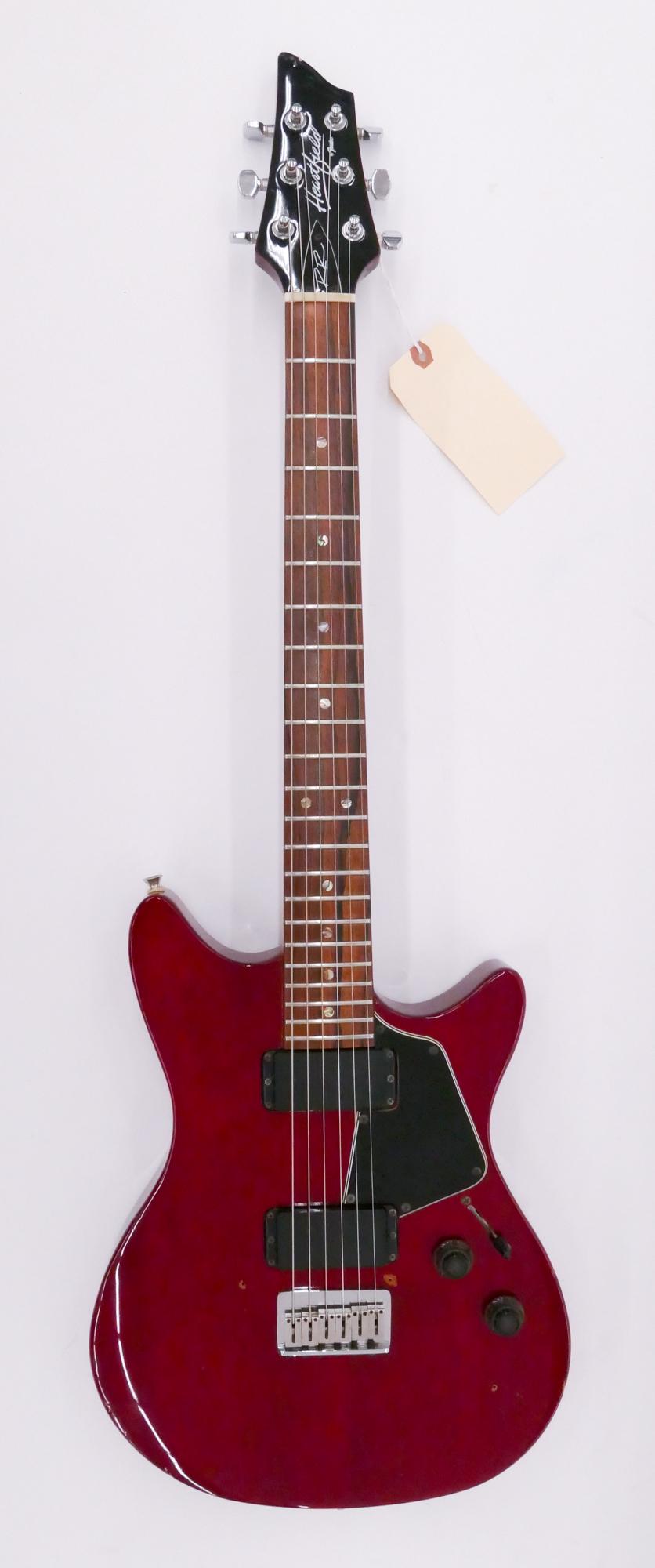Fender Heartfield RR58 Electric Guitar, 1980: Fender Heartfield RR58 Electric Guitar, 1980's. Serial #J91716. Made in Japan. Comes with original hardshell case. Cherry color mahogany body and neck, rosewood fingerboard, hardtail bridge, through-b