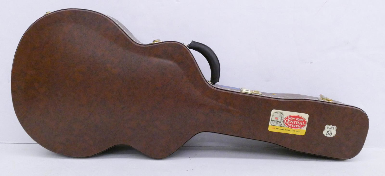 Gibson ES335 Electric Guitar Case, 2000's: Gibson ES335 Electric Guitar Case, 2000's. Black flecked brown tolex with gold hardware and hot pink plush interior with satin overlay. Reproduction of 1959 335 case. Condition- Excellent as New.