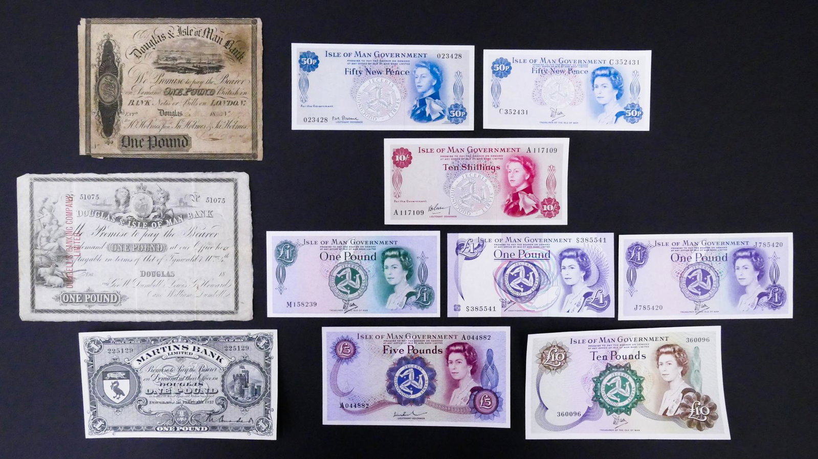 Isle of Man. 11pc 1843-1983: Isle of Man. 11pc 1843-1983. Includes 1843 Douglas & Isle of Man Bank 1 Pound Pick S131, Douglas & Isle of Man Bank 1 Pound Pick S141, Martins Bank Limited 1 Pound 1.2.1957 Pick 19b, and 8pc UNC 1961-