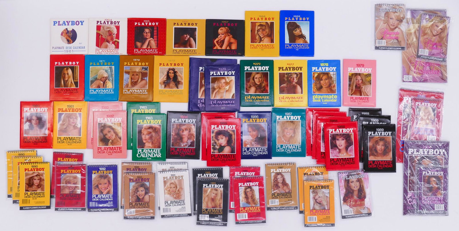 60pc Playboy Playmate Desk Calendars 1961-2004: 60pc Playboy Playmate Desk Calendars 1961-2004. Includes some duplicates. 1961-99 have original sleeves and most have not been opened. Most 1990-2004 are still in plastic packaging and are in like new