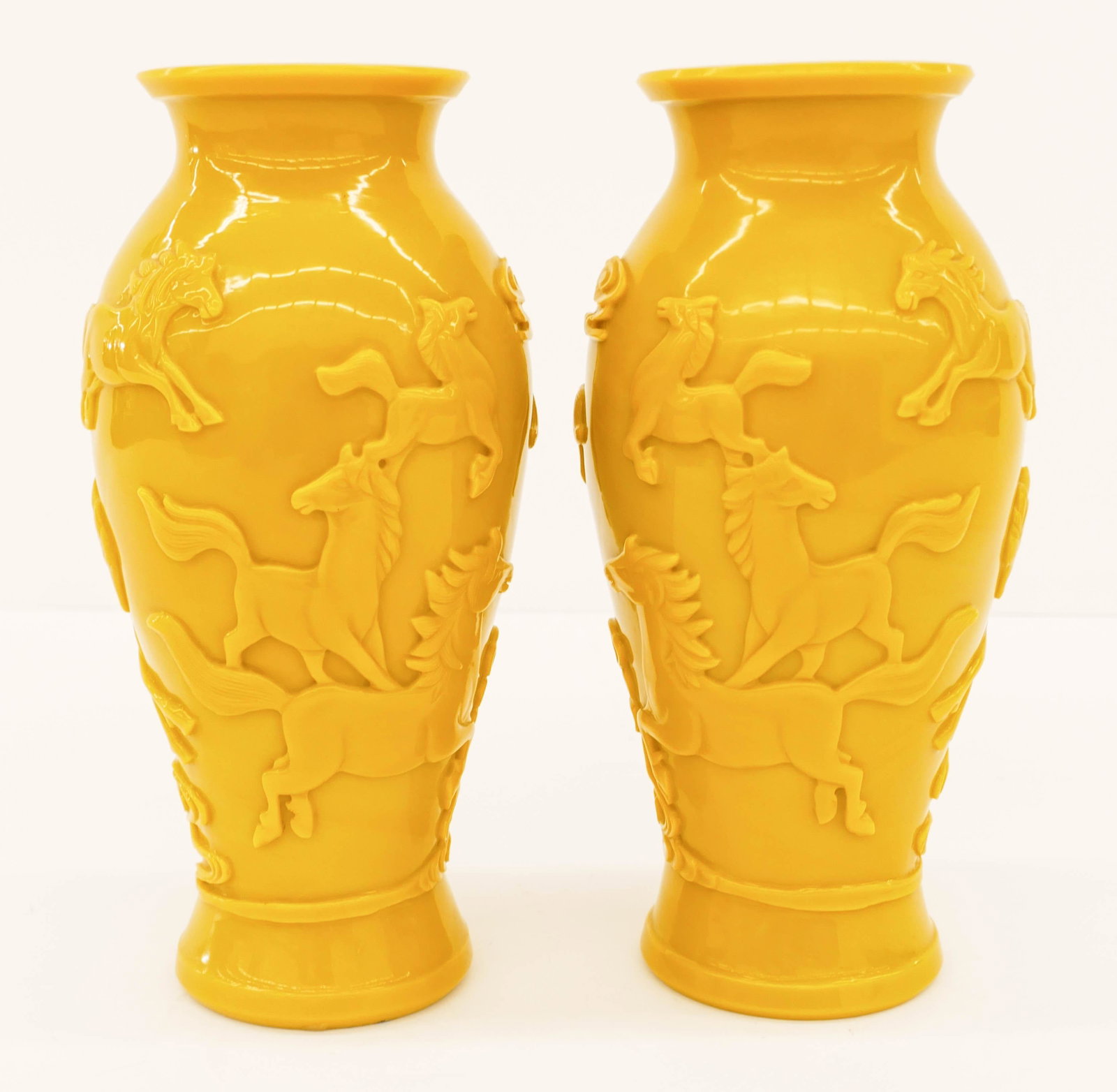 Pair Chinese Yellow Peking Glass Horse Vases: Pair Chinese Yellow Peking Glass Horse Vases 10''x4.75''. True opposing pair of deep carved vases with eight horse motifs. Unmarked. Excellent condition. First half of the 20th century, Republic era.