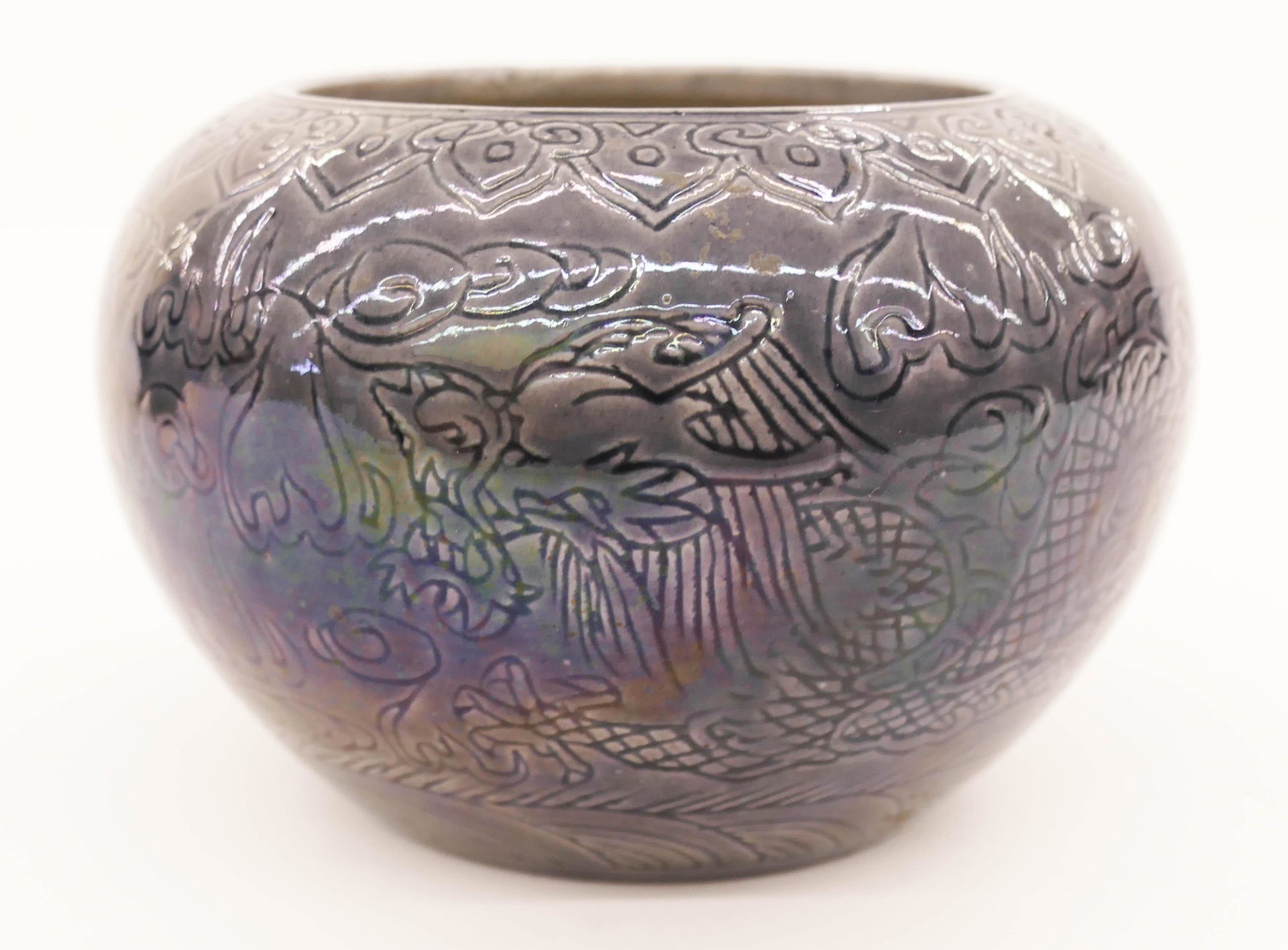 Chinese Kangxi Aubergine Dragon Bowl: Chinese Kangxi Aubergine Dragon Bowl 3.5''x5.25''. Begging bowl form with incised decoration of five-clawed imperial dragons chasing the flaming pearl. Six character incised Kangxi mark and likely of 