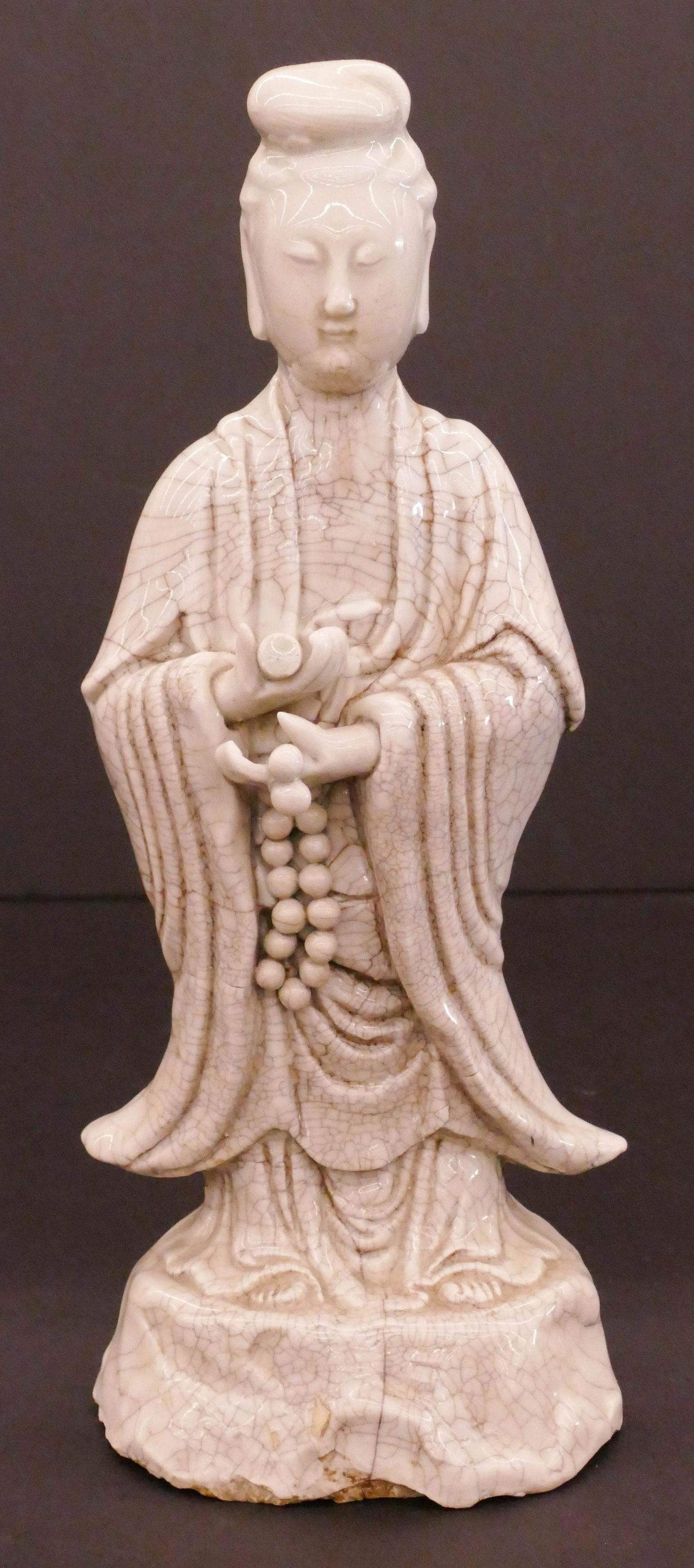 Chinese 18th Cent. Blanc de Chine Guanyin: Chinese 18th Cent. Blanc de Chine Guanyin 11.5''x5''. A heavy solid porcelain standing guanyin holding prayer beads and scroll. Comes on fitted rosewood stand 1.5''. Impressed double gourd mark on ver