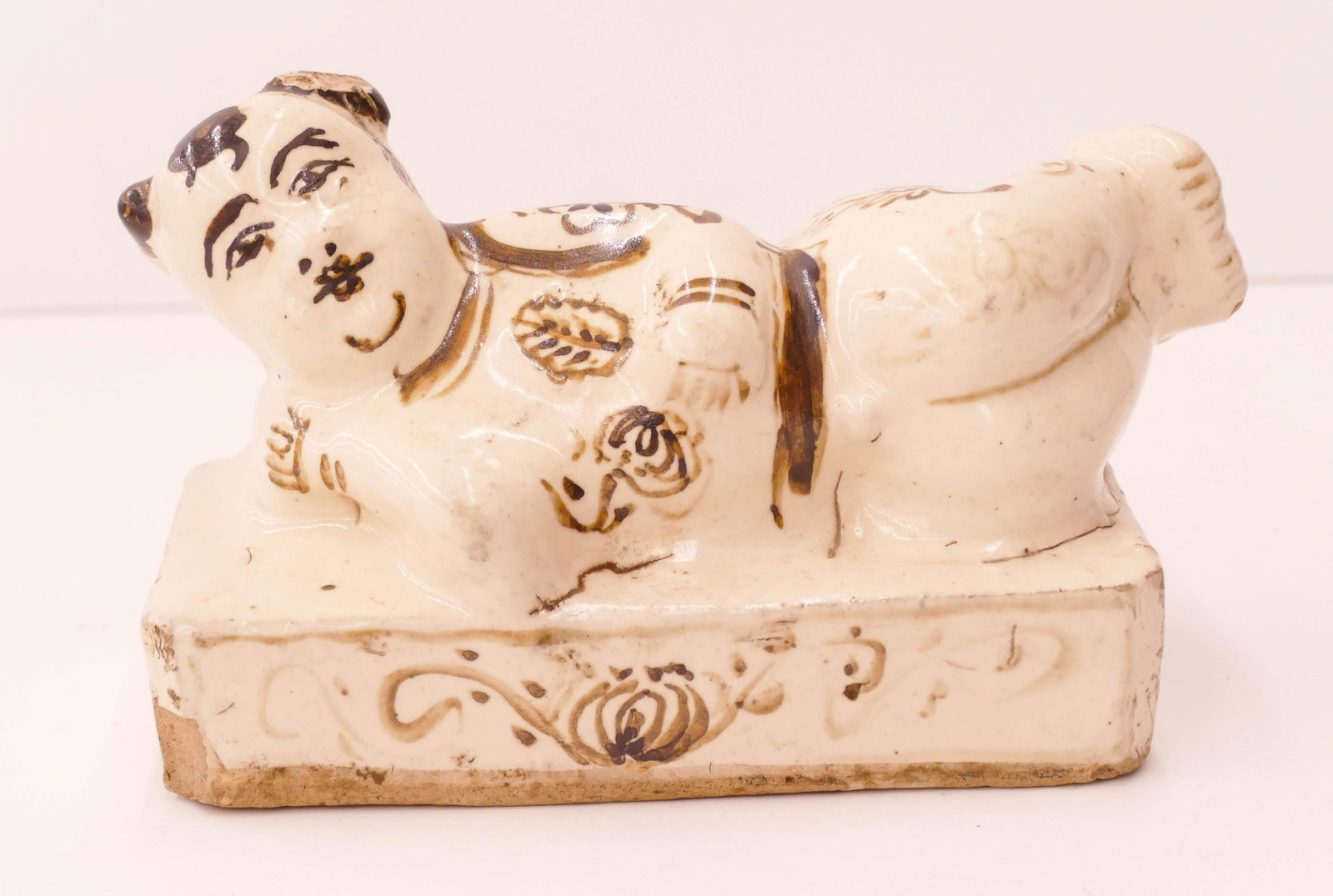 Chinese Qing Cizhou Child Roof Tile: Chinese Qing Cizhou Child Roof Tile 4.5''x8''. Unusual figural reclining boy tile. Some glaze chipping to edges and firing cracks. 18th or 19th century, Qing dynasty.