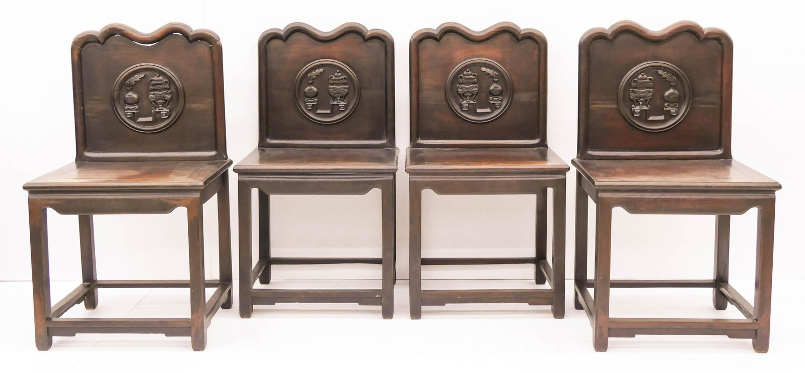 Set 4 Chinese Qing Rosewood Censer and Vase Chairs: Set 4 Chinese Qing Rosewood Censer and Vase Chairs 38''x21''x17''. Two opposing pairs of straight chairs with relief carved censer and vase motifs on backs. Some scattered surface wear from age. 19th 