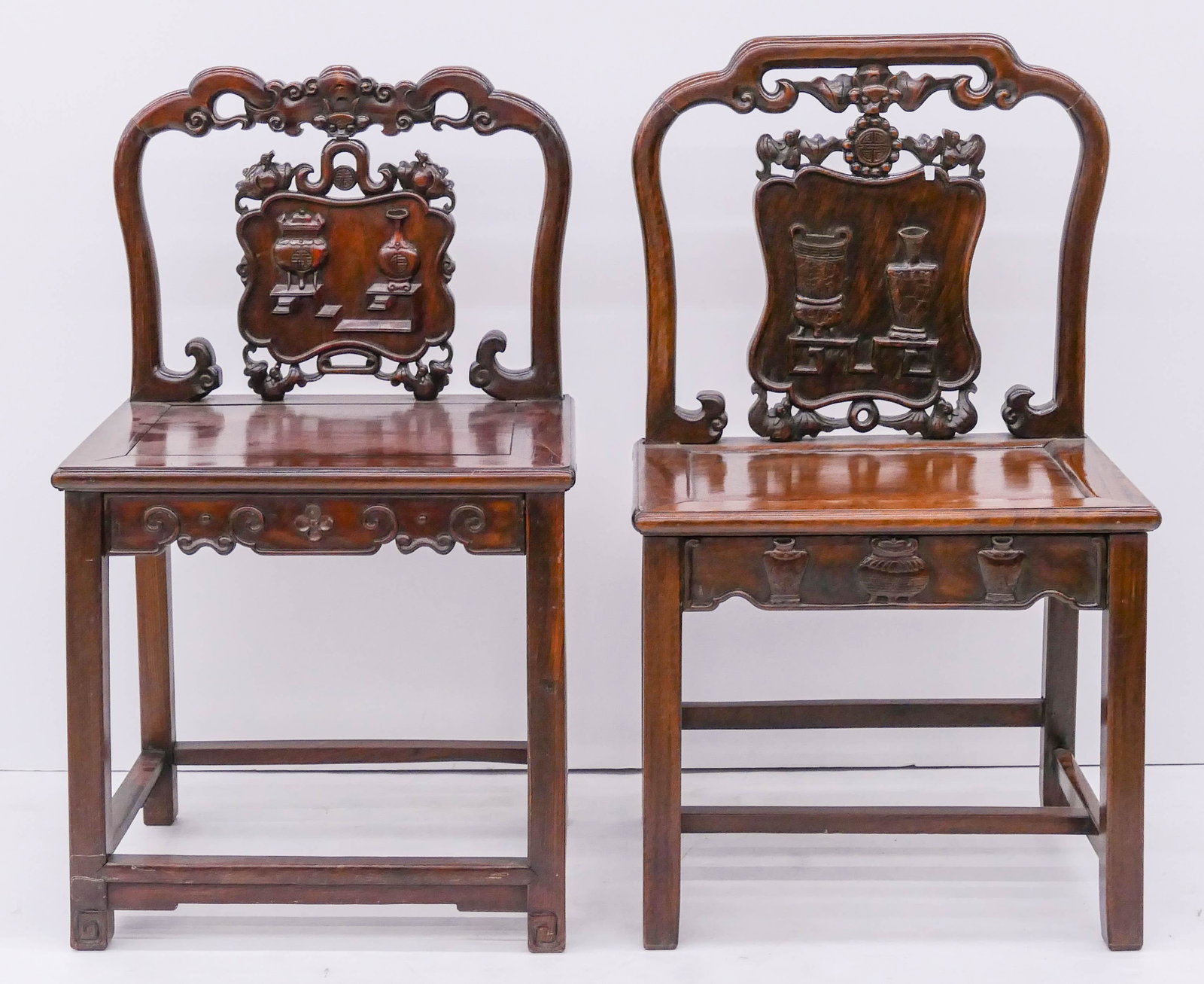 2pc Chinese Qing Rosewood Chairs: 2pc Chinese Qing Rosewood Chairs 36''x21''x17'' Approx. A duo of pierced carved straight chairs with relief censer and vase motifs. Professional brace repairs under seats. 19th century, Qing dynasty.