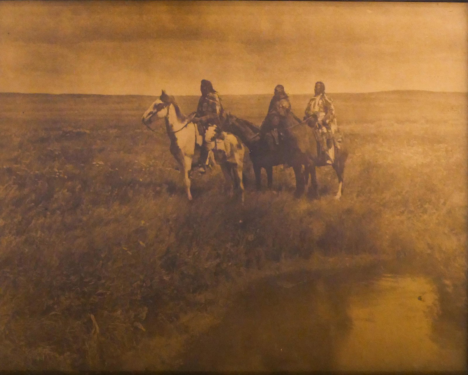 After Edward Curtis ''''The Three Chiefs'' Orotone: After Edward Curtis ''''The Three Chiefs'' Orotone Photograph. 8''x10'' Image. A reproduction image, likely by Fred Gomez, of Curtis's famous image. Antique closed corner frame 11''x13''. Excellent co