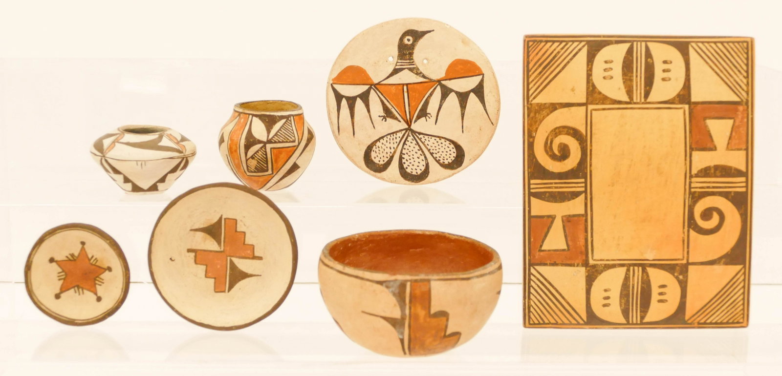 7pc Old Southwest Pueblo Pottery Miniatures: 7pc Old Southwest Pueblo Pottery Miniatures. Santa Clara and Acoma. Sizes range from 2.5'' to 7''. Includes tile, 2 small jars, bowl, and 3 decorated small dishes. Some slight edge chipping and surfac