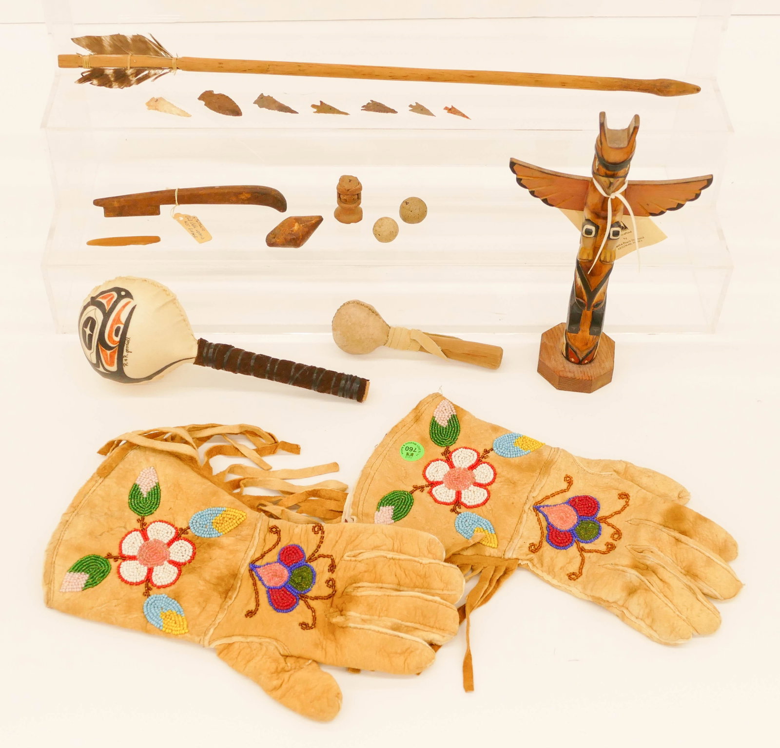 18pc Old Indian Implements & Artifacts: 18pc Old Indian Implements & Artifacts. Includes pair Columbia River beaded gauntlet gloves (12''), signed Wolln cedar totem model (10''), R&R Goodall leather rattle (9''), small leather rattle (5.5''