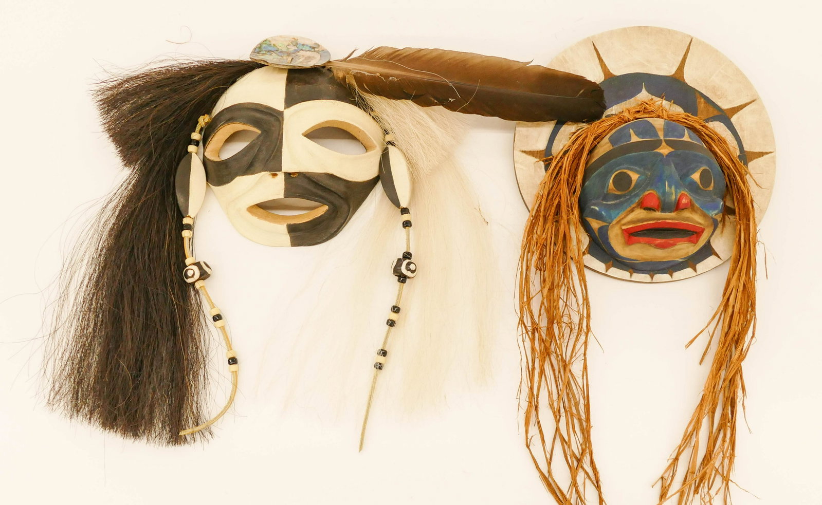 2pc Contemporary NW Coast Masks: 2pc Contemporary Native Coast Masks. Includes Owen Walker (Alaska) Moon Mask, 1997 (10'' diameter), and Gerald Rancourt Tsonakwa (Abenaki) 'Baggattasidak' Mask, 2000 (9''). Signed and dated on versos.