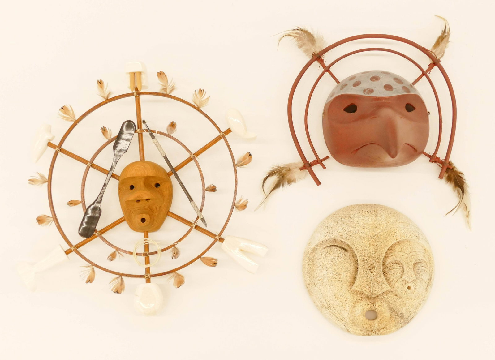 3pc Yupik & Eskimo Masks: 3pc Yupik & Eskimo Masks. Includes Carved Cedar Bird Mask signed I. Daga (9''), Eskimo Hunter Spirit Mask signed Lenwood Saccheus 1992 (12''), and G. Bailey Whalebone Mask (7''). Excellent condition.