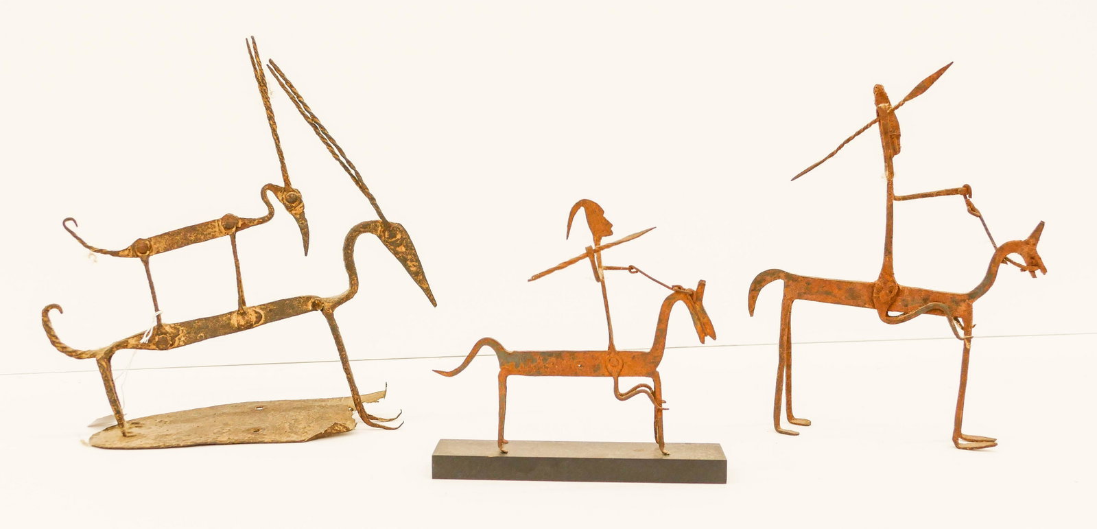 3pc Old Dogon Wrought Iron Equestrian Figures: 3pc Old Dogon Wrought Iron Equestrian Figures. Early 20th century. Measures 8''x9'' to 14''x13.5''. Includes 2pc hunting figures and 1pc double antelope figure. Largest has break to platform. Scattere