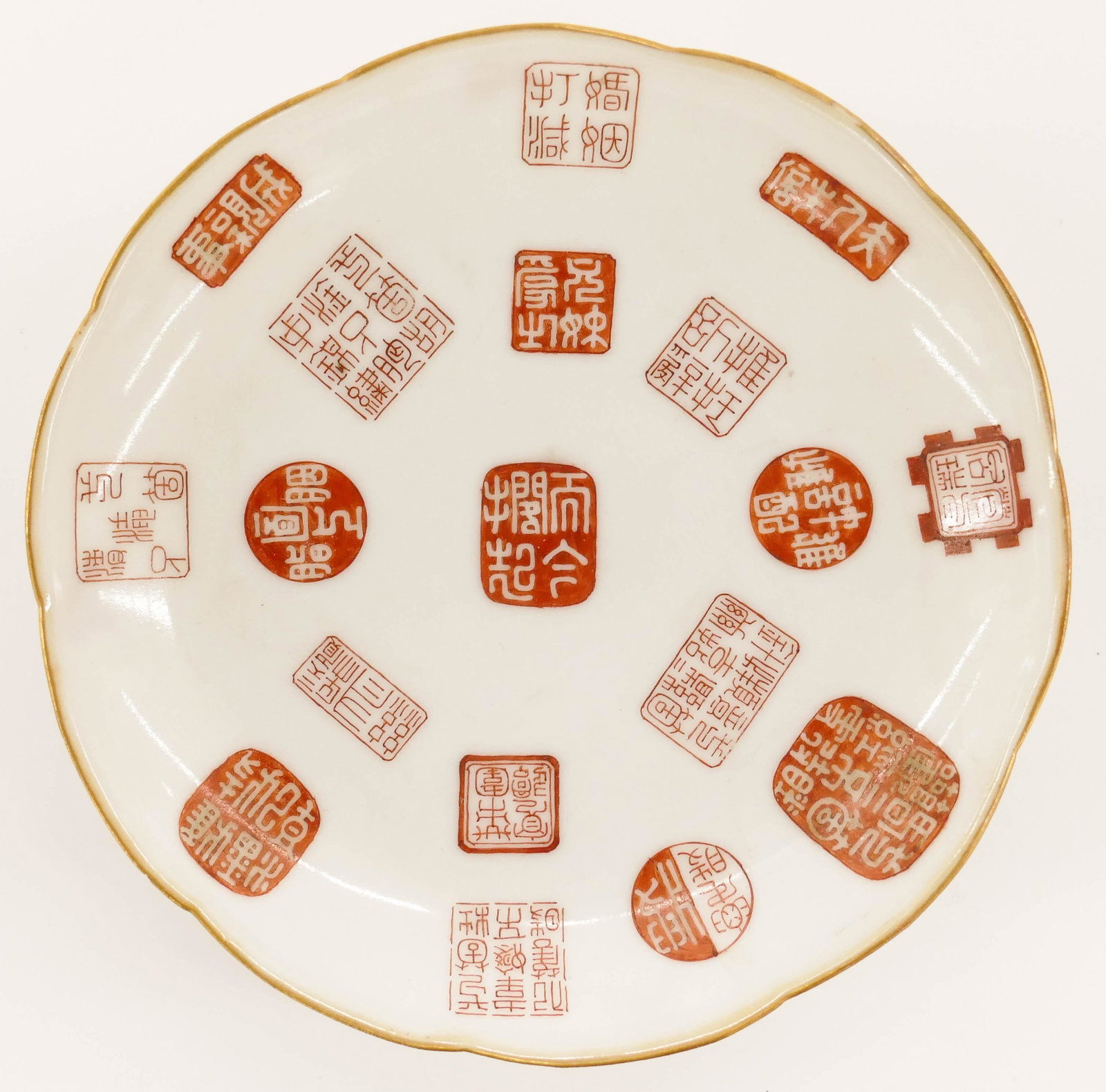 Chinese Tongzhi Red Seal Porcelain Dish: Chinese Tongzhi Red Seal Porcelain Dish 5.5''. Unusual dish with various copper red enameled seal motif. Gold gilt rim. Red enameled Zhuanshu Tongzhi seal mark and of the period. Slight flake chip on 