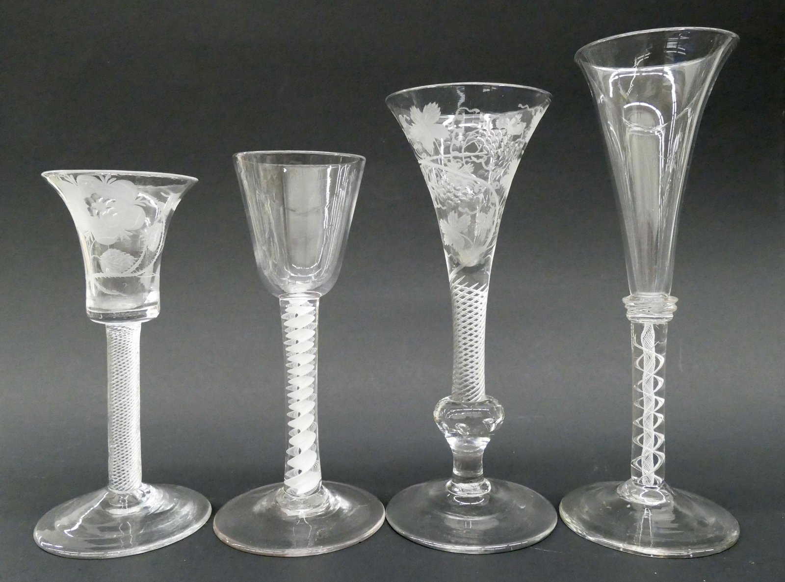 4pc 18th Century English Twist Stem Wine Glasses: 4pc 18th Century English Twist Stem Wine Glasses. Includes Jacobite wine glass with Tudor rose engraving c.1750 (6''), a glass with vine engraving and multiple tears in knop c.1770 (7''), a white enam