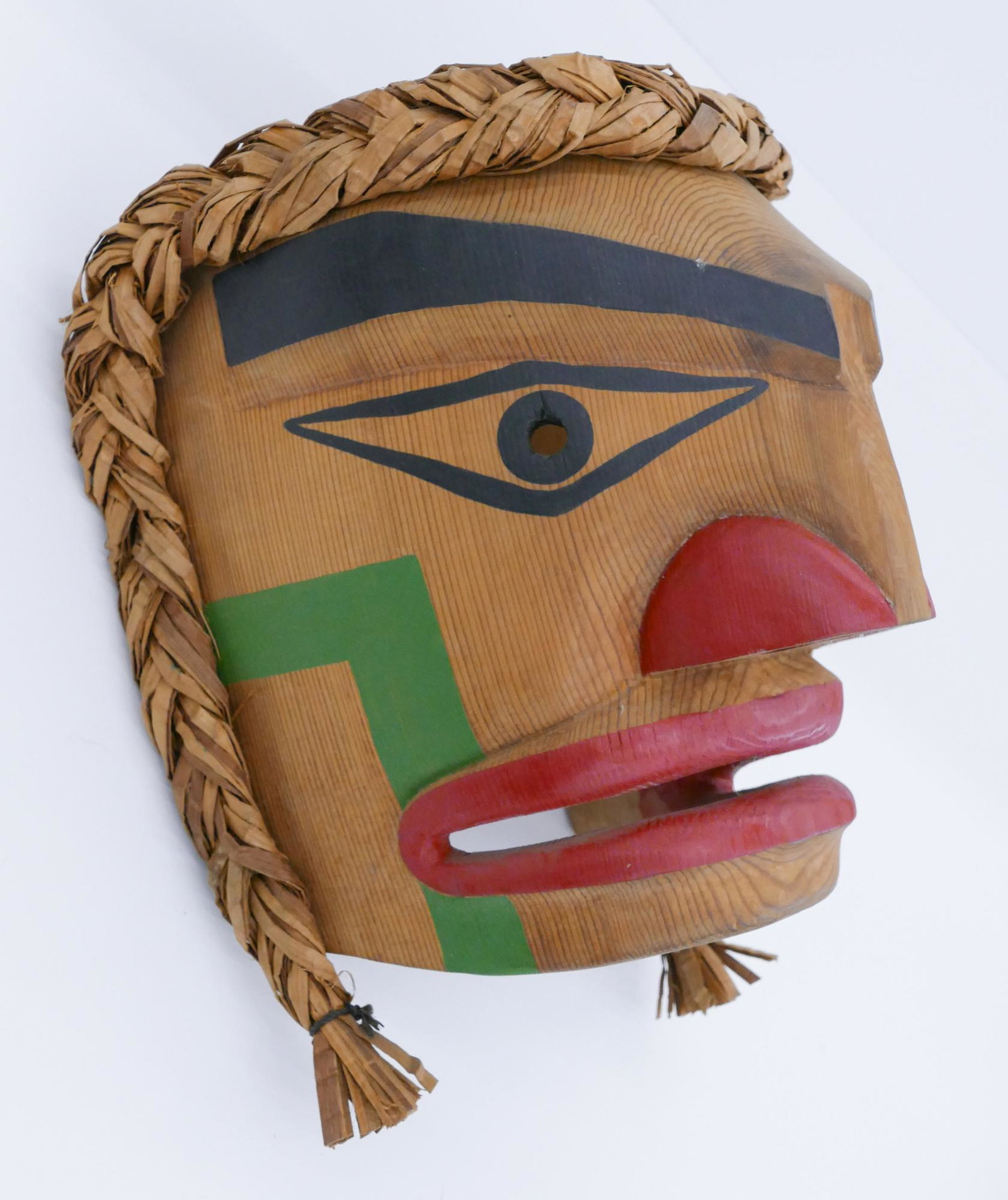 Reb Parker ''Makah Warrior Mask'' 2000 Cedar: Reb Parker (20/21st Cent. Makah) ''Warrior Mask'' 2000 Cedar 9''x8''x7''. Carved and polychrome painted u-form human mask. Woven cedar bark hair measuring 11'' long. Signed on verso. Excellent conditi