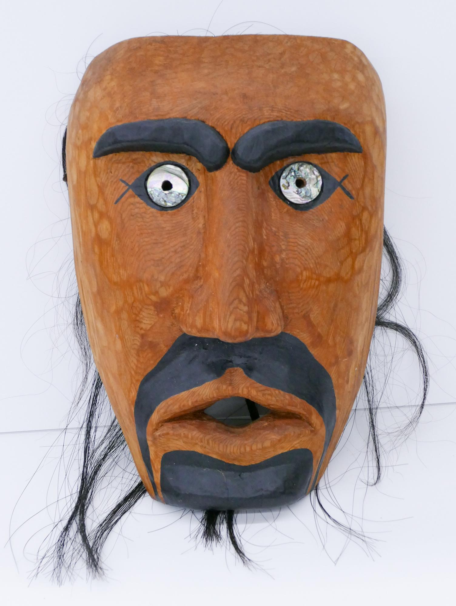 Sam White ''Portrait Mask'' 1994 Cedar: Sam White (20/21st Cent. Klallam) ''Portrait Mask'' 1994 Cedar 11''x7.5''x5''. Carved and painted human mask with applied abalone shell eyes. Black synthetic hair 26'' long total. Signed on verso. Exc