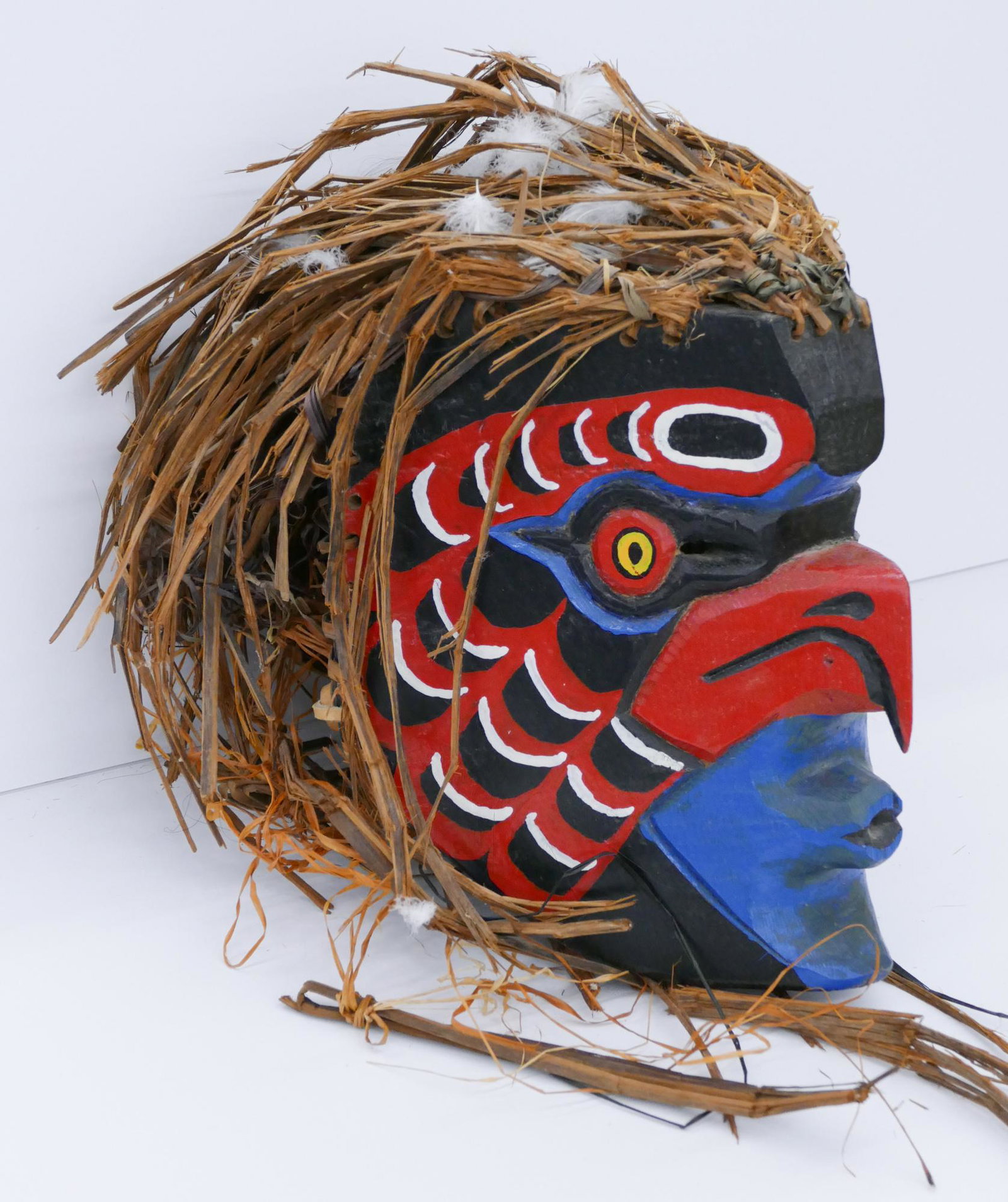 Chief Floyd Charles Jr. ''Hawk Mask'' Cedar: Chief Floyd Charles Jr. (20/21st Cent. S'Klallam) ''Hawk Mask'' Cedar 10''x8''x7''. Carved and polychrome painted bird mask. Woven cedar bark hair measuring 28'' long total. Signed on interior. Overal