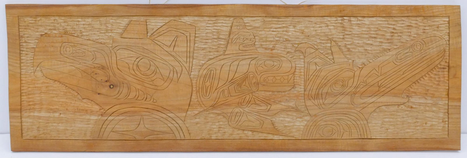 Lewis Romberg ''Raven Eagle Killer Whale'' 2009 Cedar: Lewis Romberg (20/21st Cent. Makah) ''Raven Eagle Killer Whale'' 2009 Cedar Panel 12''x37.5''. Relief carved Northwest Coast u-form wall plaque. Signed on verso. Excellent condition.
