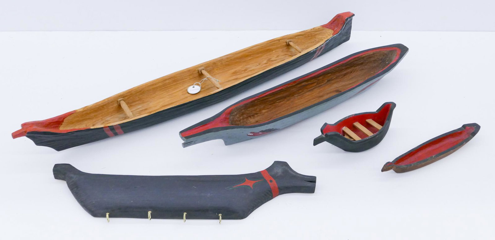 5pc Makah Northwest Coast Cedar Canoe Models: 5pc Makah Northwest Coast Cedar Canoe Models 9'' to 35''. Includes a larger carved and painted canoe by Sam White, a carved canoe with sisiutl sea serpent painted motif, a canoe key rack by Lewis Romb
