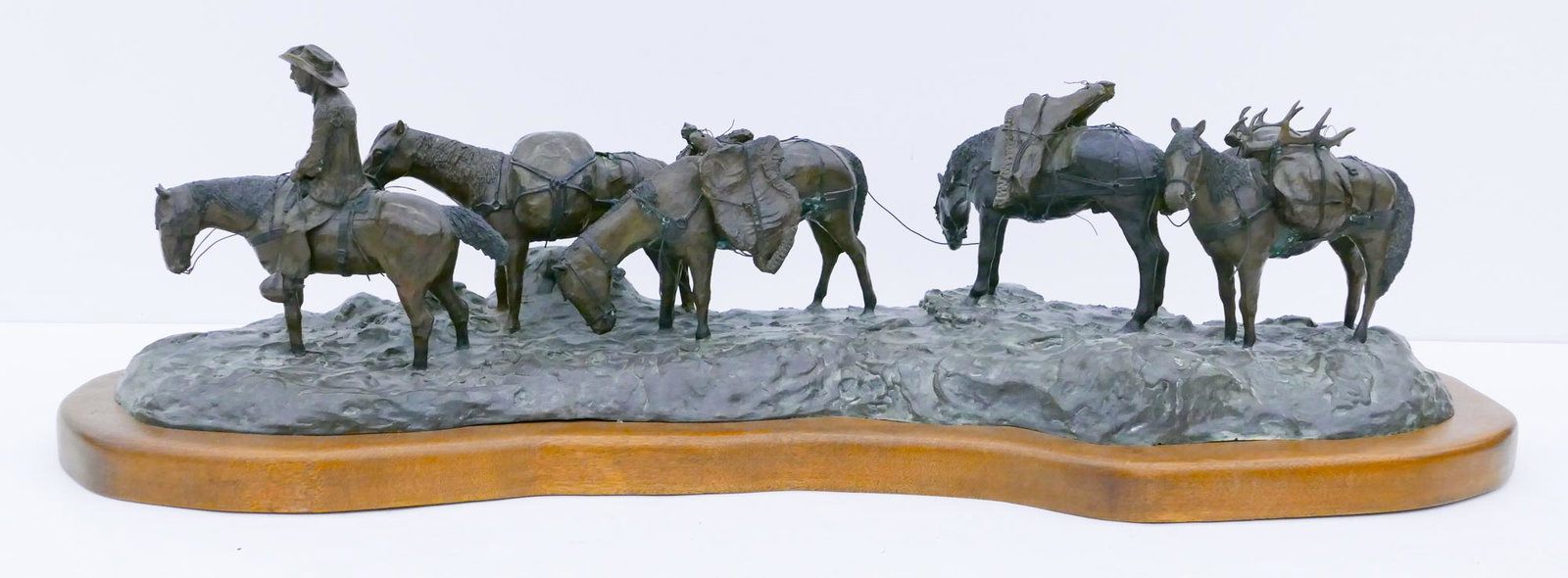 Jack JP Kelley ''The Packer'' (Pack Train) 1970 Bronze: Jack ''J.P.'' Kelley (1927-2005 American) ''The Packer'' (Pack Train) 1970 Bronze Sculpture 12''x45''x14''. A large western bronze sculpture group. Signed and numbered 2 of 20 edition on base. Overall