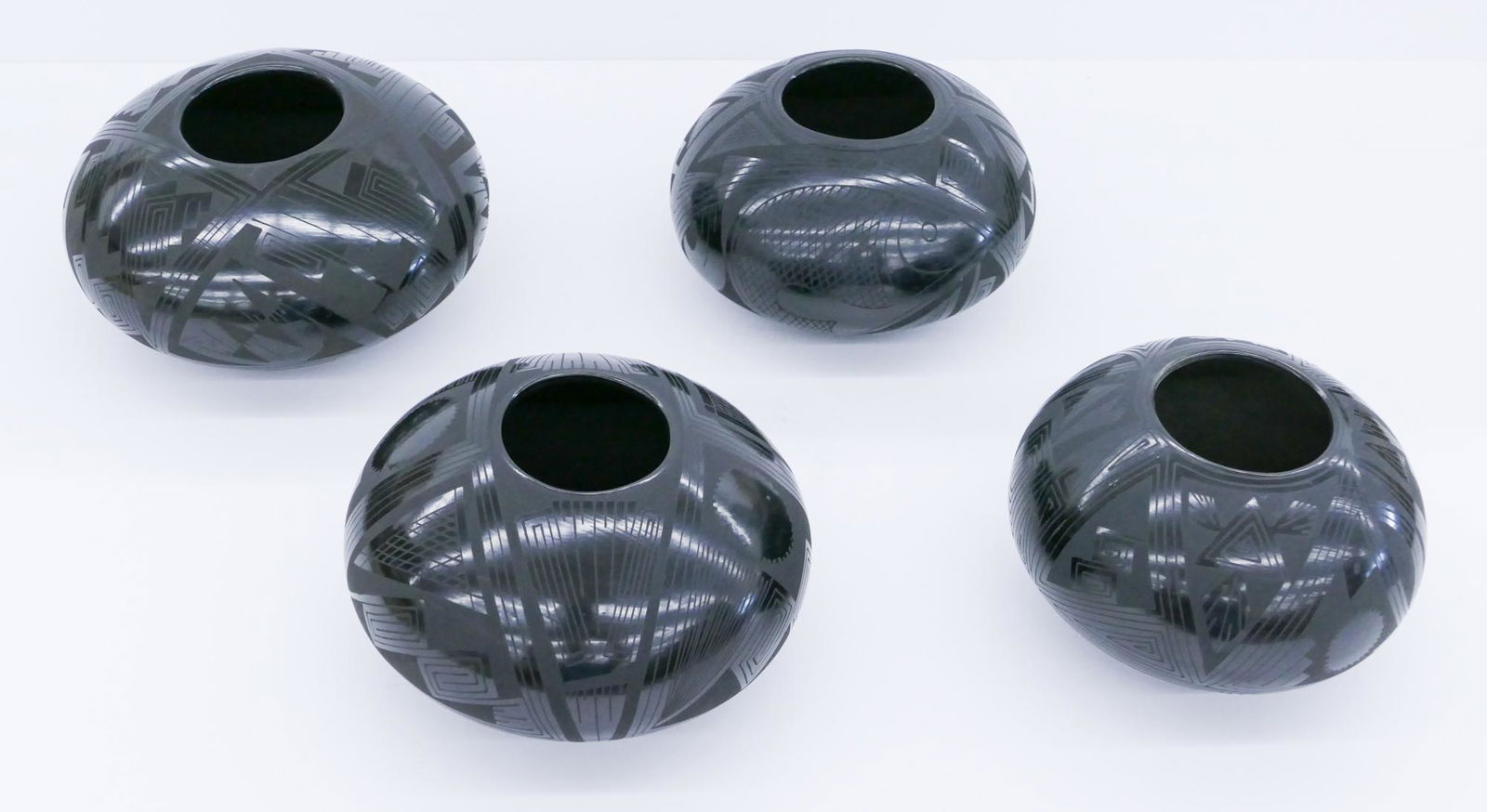 4pc Michael Wisner Decorated Blackware Jars: 4pc Michael Wisner (b.1963 American) Decorated Blackware Jars 6'' Approx. Southwest geometric motifs. Signed on bottom. A few scattered surface marks. Overall excellent condition.