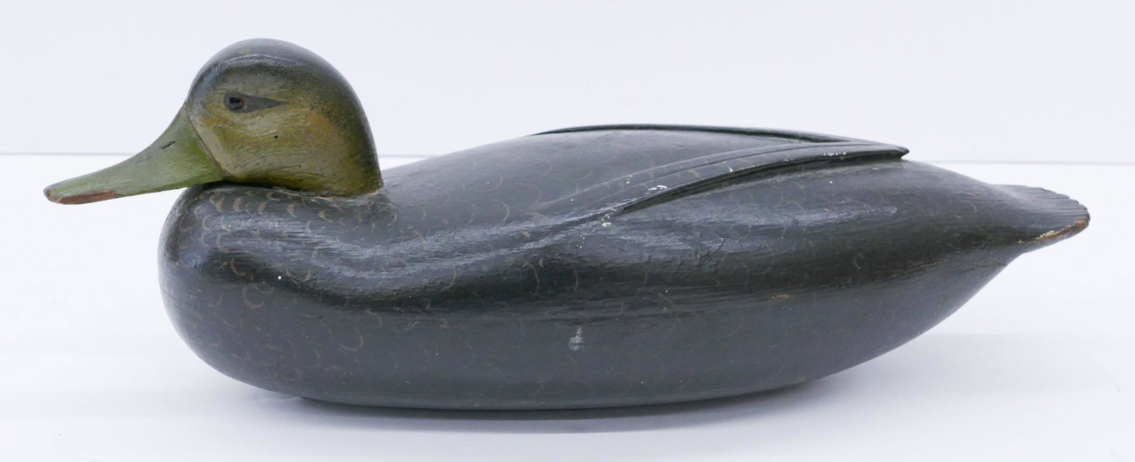 Antique Resting Black Duck Wood Decoy: Antique Resting Black Duck Wood Decoy 16''. Finely painted with inset glass eyes. Some minor chipping to beak and tail edges. Overall excellent condition. Early 20th century.