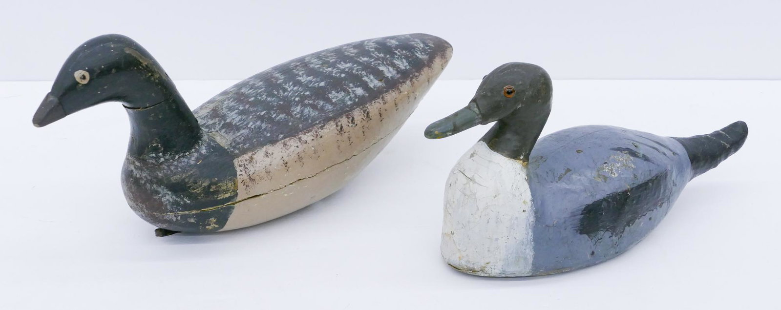 2pc Antique Wood and Canvas Duck Decoys: 2pc Antique Wood and Canvas Duck Decoys 14.5'' and 17''. Unsigned. Scattered surface wear from use.