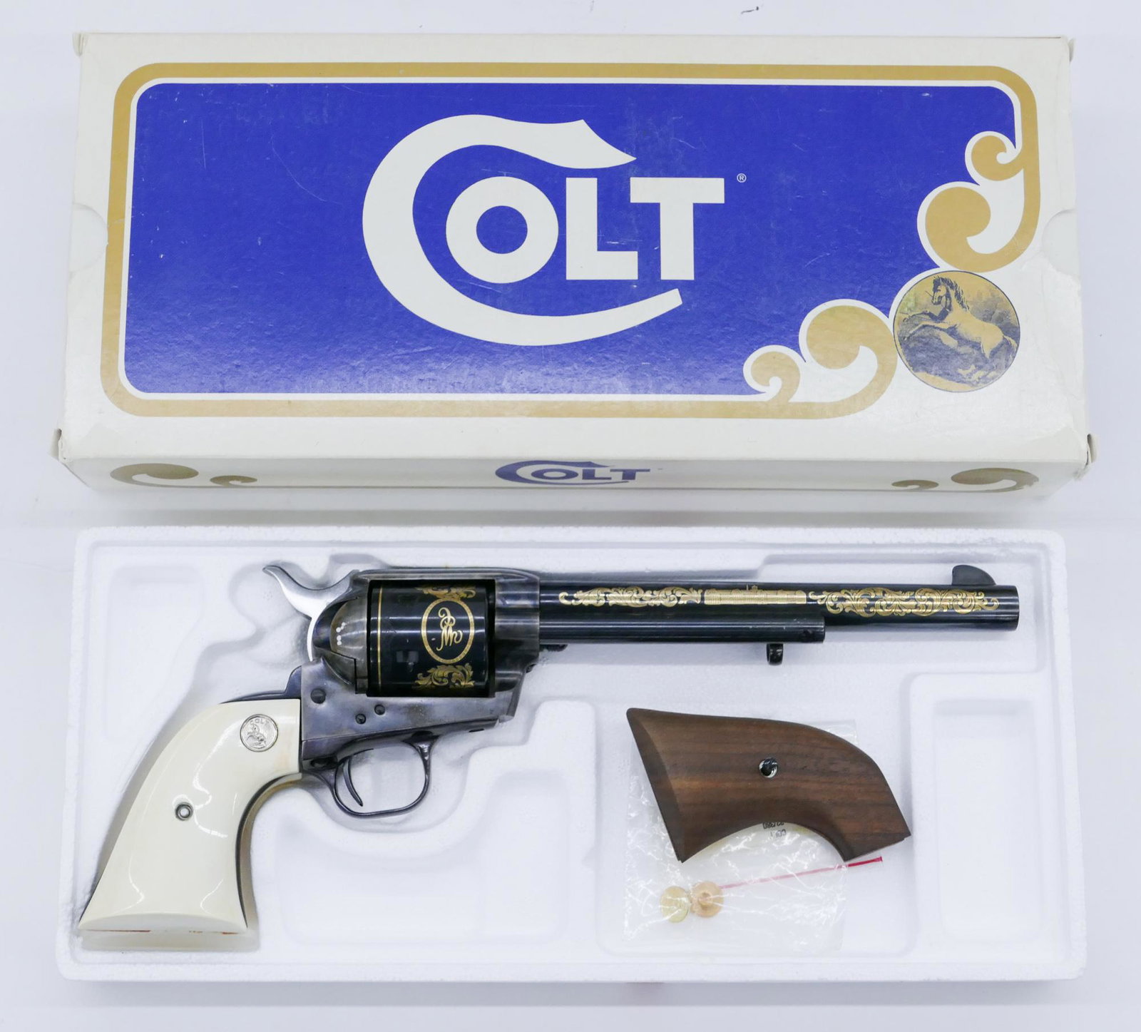 Colt SAA .44-40 Win. Commemorative Revolver in Box: Colt SAA .44-40 Win. Commemorative Revolver in Box. Factory gold inlaid with two sets of grips. It has a 7'' barrel and measures 13'' total. Serial number 2230WC. Original box and papers. Clean, unfir