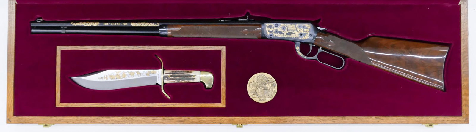 Winchester Model 94 Texas Sesquicentennial & Bowie Knife: Winchester Model 94 Texas Sesquicentennial & Bowie Knife Cased Set 47''x13''. Includes a gold inlaid lever action .38-55 Win. rifle with 24'' barrel. Serial number TSR0025. Also a Western engraved bow