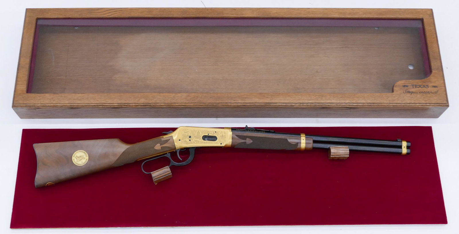 Winchester Model 94 Texas Sesquicentennial Cased Rifle: Winchester Model 94 Texas Sesquicentennial Cased Rifle 43''x11''. Commemorative 18'' barrel .38-55 Win. lever action rifle. Serial number TEX00025. Comes in oak glass front display case. Clean, unfire
