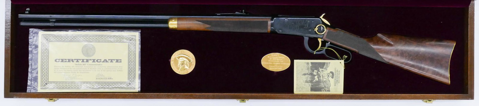 Winchester Model 94 Buffalo Bill .30-30 Cased Rifle: Winchester Model 94 Buffalo Bill .30-30 Commemorative Cased Rifle 47''x10''. Hexagonal 26'' barrel lever action rifle. Serial number WC05. Limited edition numbered 5 of 300. Custom fitted case and bro