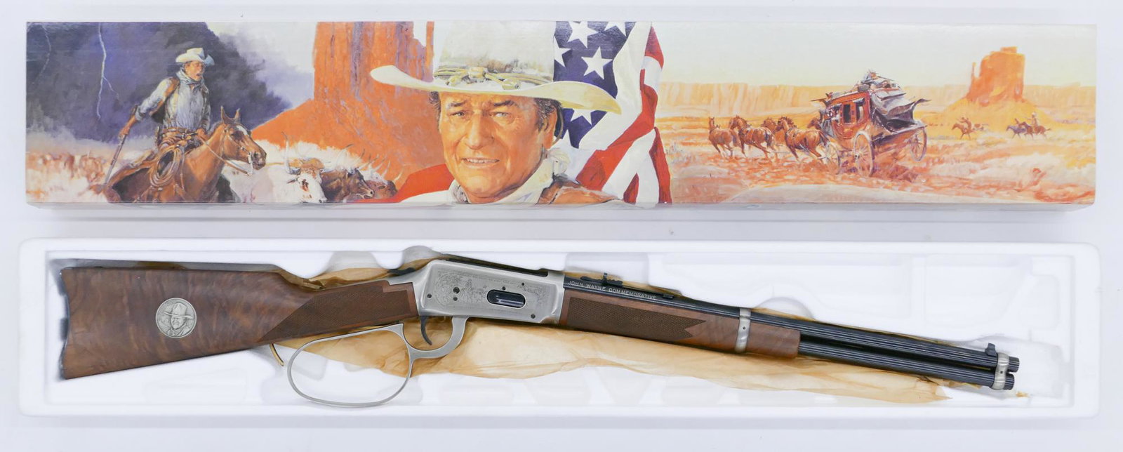 Winchester Model 94 John Wayne .32-40 Rifle in Box: Winchester Model 94 John Wayne .32-40 Rifle in Box. Lever action .32-40 Win. rifle with 18'' barrel. Serial number JW 9931 with matching box. Clean condition with some light rusting to chamber undersi