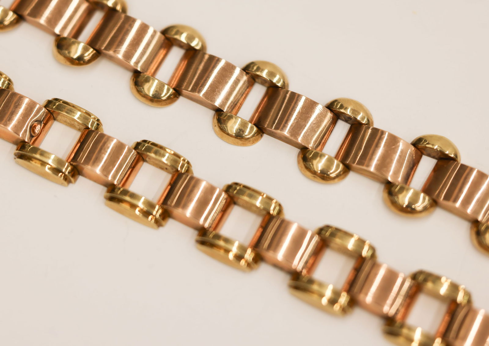 2pc Austrian Art Deco 14k Two-Tone Bracelets: 2pc Austrian Art Deco 14k Two-Tone Bracelets 7''. Hollow link bracelets measuring 19mm and 21mm thick. Hallmarked on clasps. A few minor dents. Pair weighs 42.3 grams total. Estate jewelry with no app