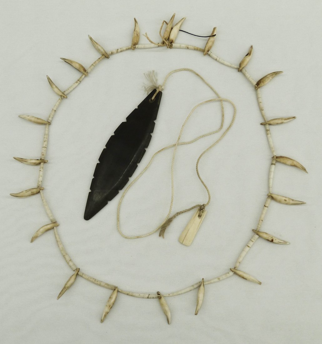 (2) Eskimo Indian Artifacts. Dentalium shell and to: (2) Eskimo Indian Artifacts. Dentalium shell and tooth necklace 34'' and a carved baleen noise maker 6''.