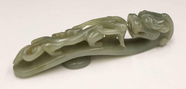 Chinese Jade Dragon Belt Hook: Chinese Jade Dragon Belt Hook 4''x1''. Carved celadon jade figural hook with pierced chilong motif. Excellent condition. 20th century or older.